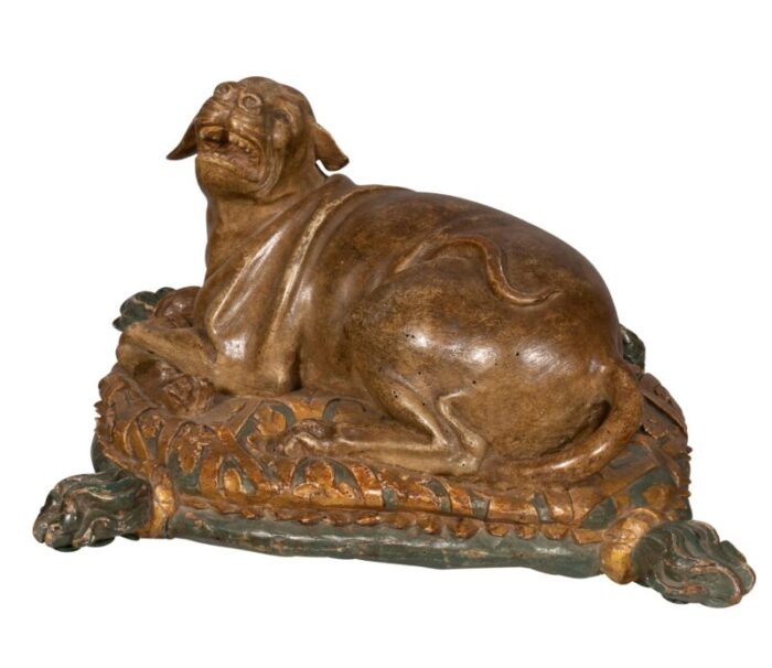 fine european carved and painted dog lying on a pillow 2743