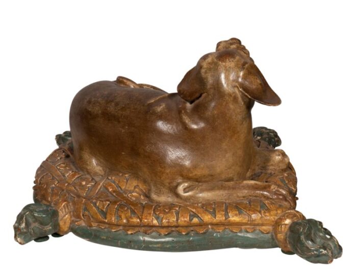 fine european carved and painted dog lying on a pillow 3893