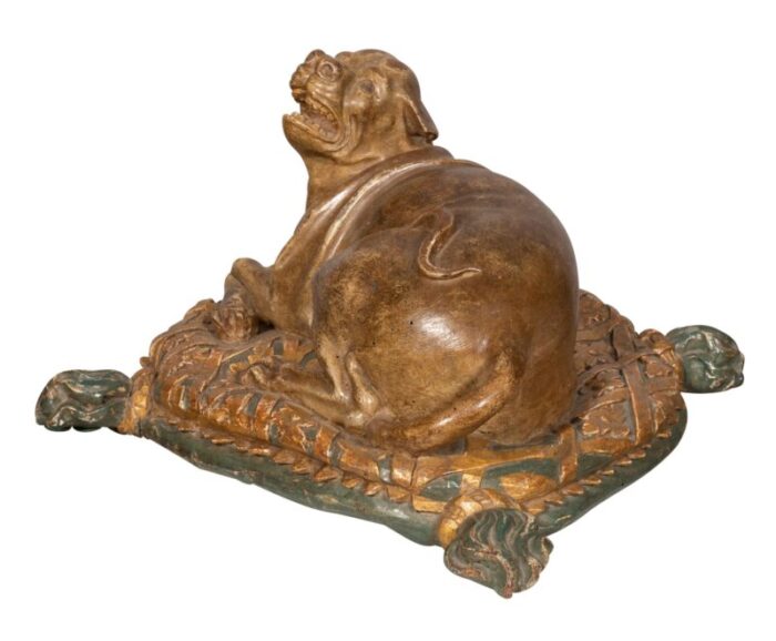 fine european carved and painted dog lying on a pillow 4109