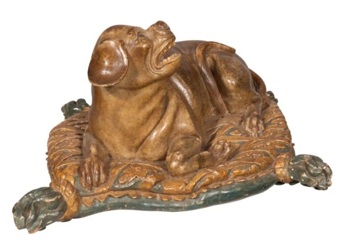 fine european carved and painted dog lying on a pillow 6847