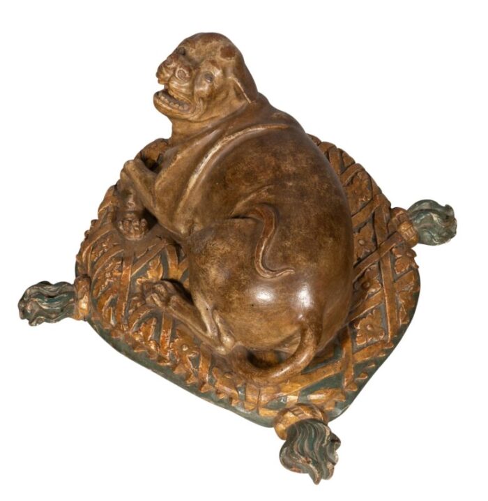 fine european carved and painted dog lying on a pillow 7064