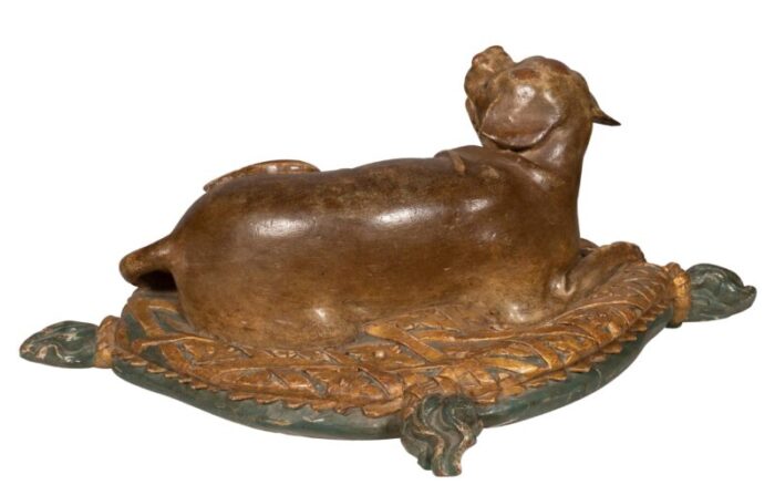 fine european carved and painted dog lying on a pillow 8453