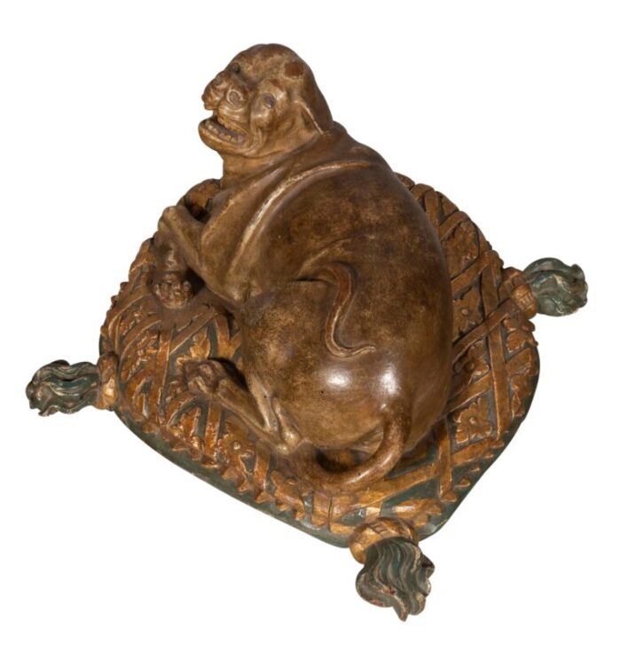 fine european carved and painted dog lying on a pillow 8695