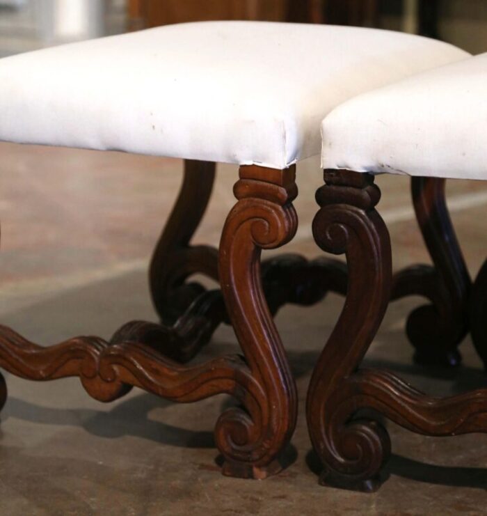 pair of 19th century french louis xiii carved walnut stools with white muslin 6603