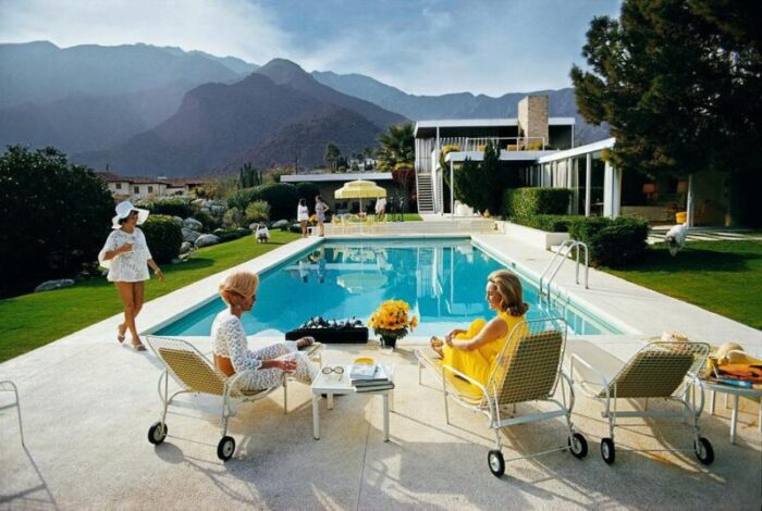 slim aarons catch up by the pool 1970s estate stamped photographic print 1841