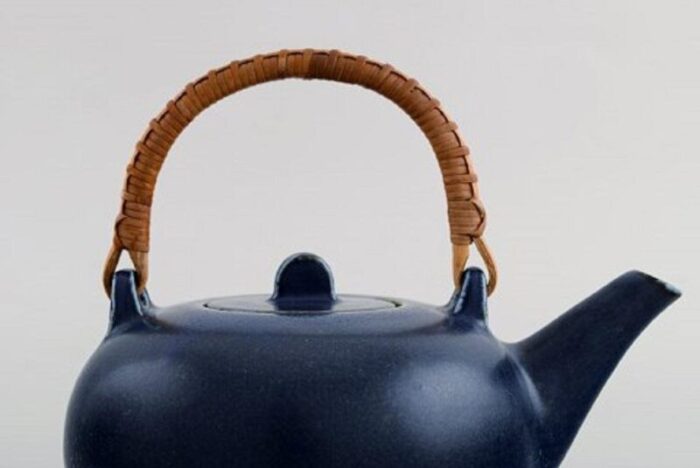 teapot in glazed ceramic with handle in wicker by eva staehr nielsen for saxbo 4