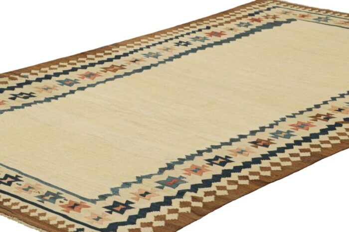 vintage kilim with beige open field and geometric borders from rug and kilim 9257